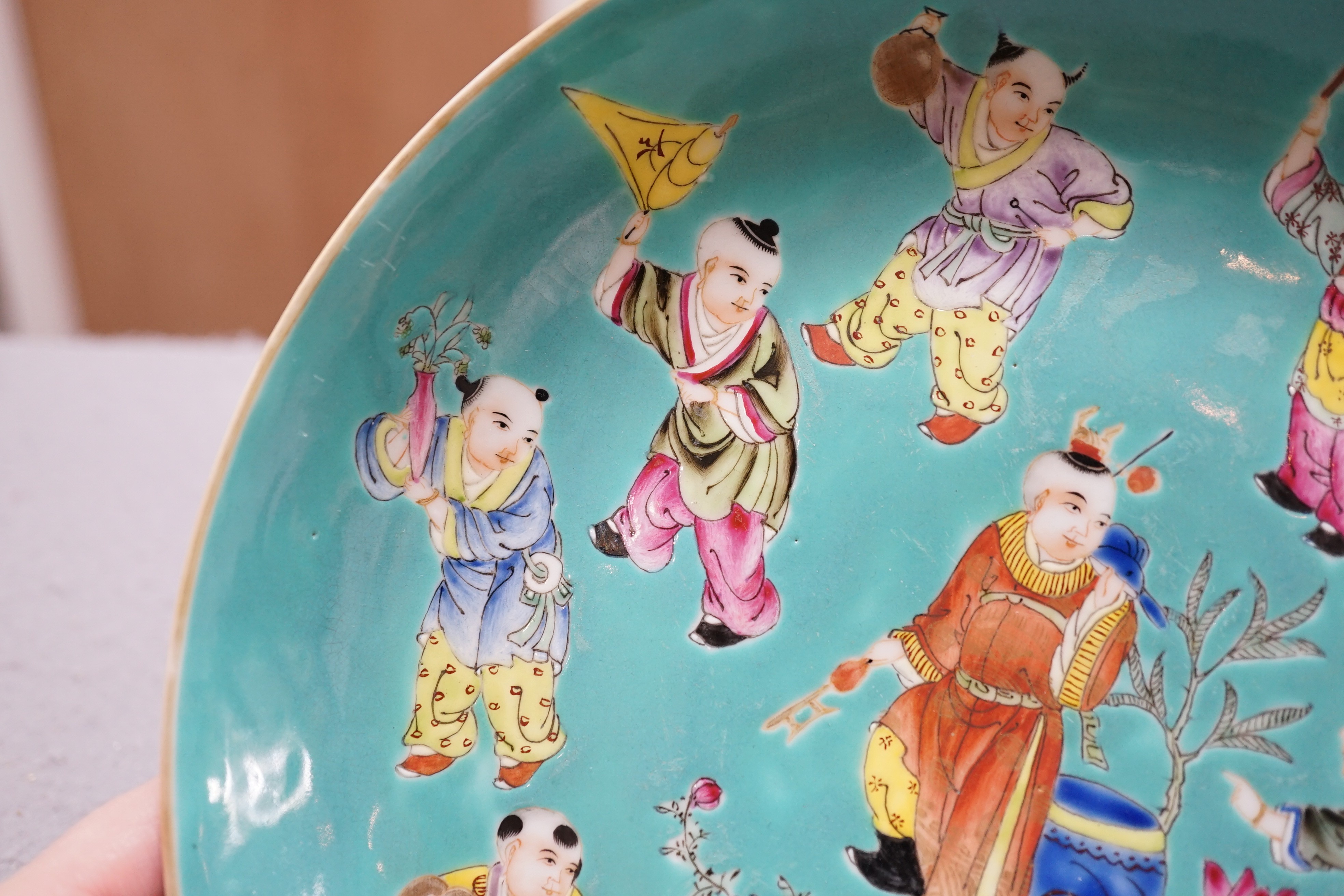A Chinese turquoise ground 'Boys' dish, Jiaqing seal mark but Republic period, 23.5cm diameter, two hairline cracks